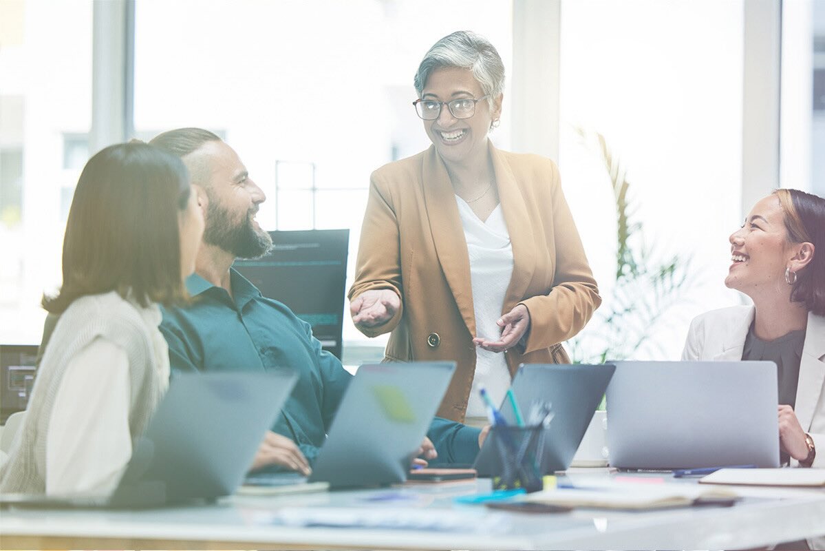 A confident businesswoman presents an idea to her peers.